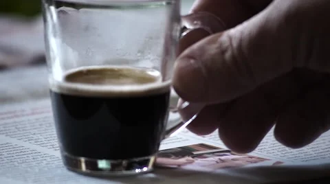 Man takes small cup of coffee Stock Footage 63176805