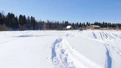 Man takes off on a snowmobile Stock Footage 87912212