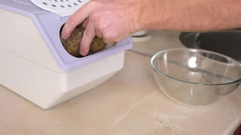 Man takes spud from vegetable container. box storing potato, onion, carrot. Stock Footage 224515785