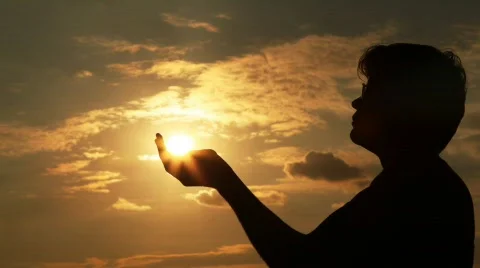 Man takes sun in hands Stock Footage 548640