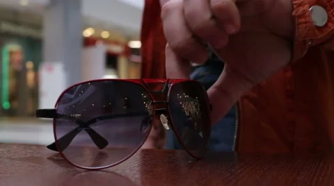 Man takes sunglasses on the table Stock Footage 50962956