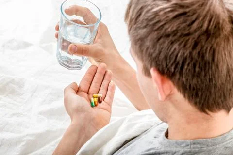 Man takes tablets Stock Photos