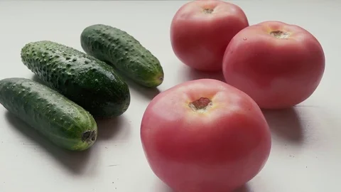 Man takes a tomato and puts back half Stock Footage 77300474