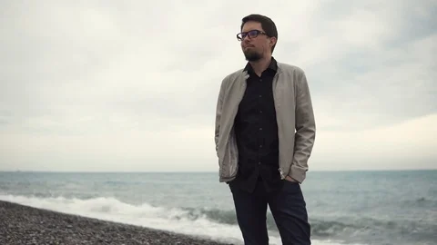 Man takes a walk on beach. Stock Footage 90902800