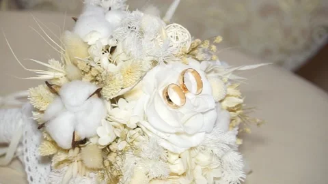 The man takes a wedding ring from the bride's bouquet Stock Footage 238020196