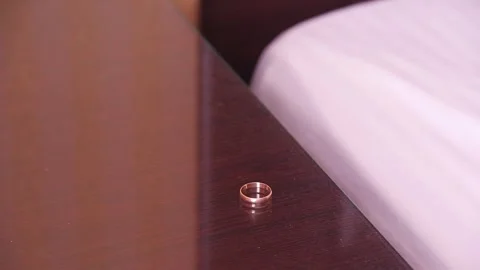 A Man Takes Off Wedding Ring, Putting It On Table Stock Footage 283846151