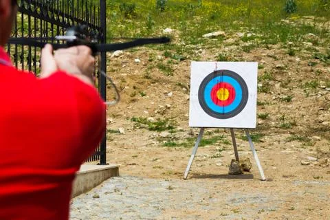 Man taking aim with a crossbow at a target Stock Photos