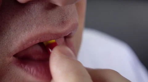 Man taking antibiotic capsule Video stock 55753488