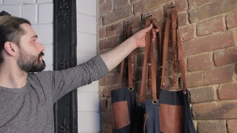 Man taking an apron before starting work. Two videos in one footage, montage. Video stock 105160110