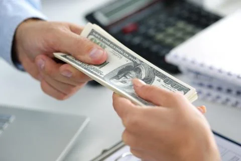 Man taking batch of hundred dollar bills Stock Photos