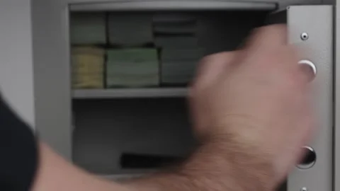 Man Taking Black Handgun Out of Open Metal Safe Box with Money Stock-Footage 340405408