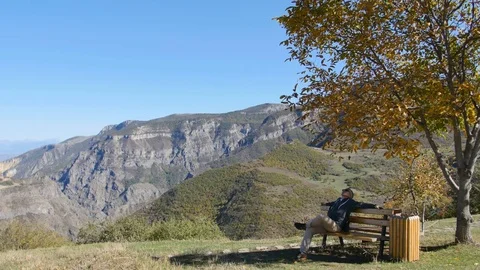 Man taking a break and relax of his trip in the mountains Stock-Footage 82603015