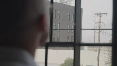 Man Taking a Break From Playing Music to Look Out of the Window Video stock 208773613