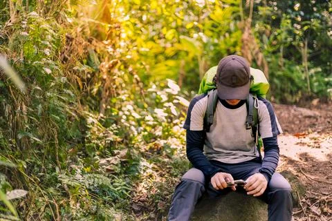 Man Taking a Break in the Wilderness, Surrounded by Nature. Enchanting Moun.. Stock Photos