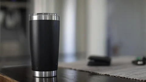 Man taking car key, wallet and tumbler with coffee out of table. Slow Motion. Stock Footage 127796122