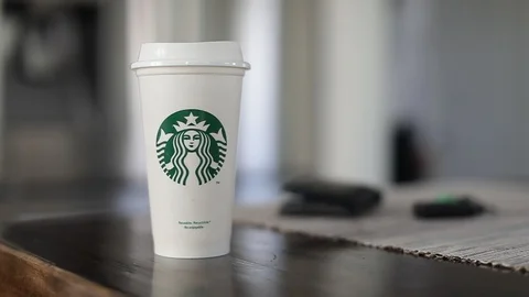 Man taking car key, wallet and Starbucks takeaway cup Stock Footage 127796159