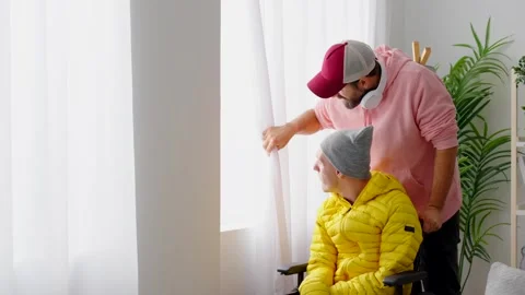 Man taking care of brother with cerebral palsy Vídeos de archivo 263597853