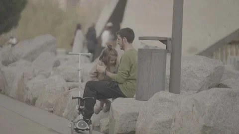 A man taking care of his child in a park in Madrid, Spain Stock Footage 345027668