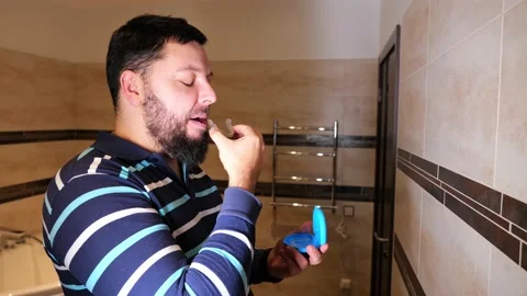 Man taking care of teeth, wearing clear orthodontic silicone transparent teeth a Stock Footage 168876193