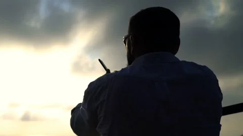 Man taking cellphone photo of Ha Long Bay in Vietnam during sunset Stock Footage 163336452