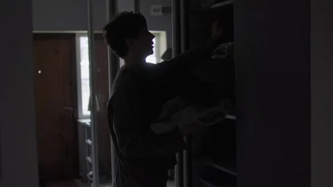 Man taking clothes from wardrobe. Decluttering, minimalism and home organization Stock Footage 327742983