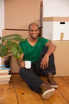 A man taking a coffee break while moving house Stock Photos