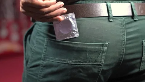 Man taking condom out of back pocket for safe sex. Stock Footage 341659810