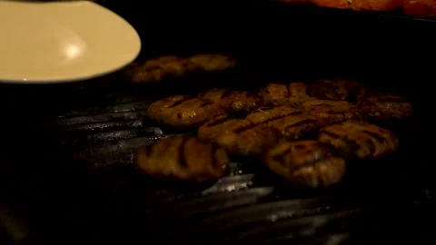 The man is taking the cooked meatballs off and placing them onto a plate 스톡 동영상 279145876