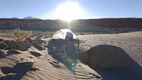 Man taking down a tent in the atacama desert Stock Footage 82723062