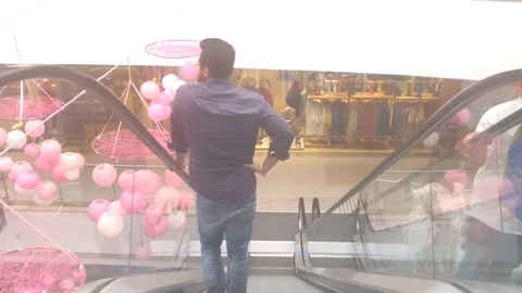 Man taking escalators in the shopping mall Stock Footage 105477092