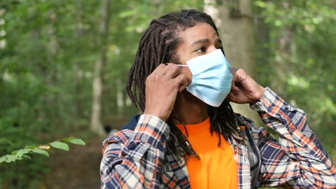 Man Taking Off Face Mask Outside Away from People Coronavirus Social Distance Stock Footage 142286740