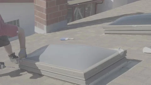Man Taking off the Frame of a Skylight Window on a Rooftop (RAW) Stock Footage 212417890