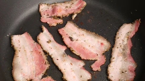 Man taking fried bacon from the pan. Stock Footage 70879183