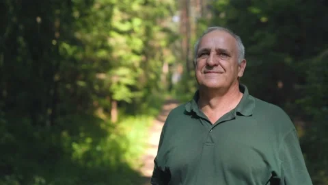 Man is taking off his mask and he taking a deep breath at the nature. Stock Footage 157072387
