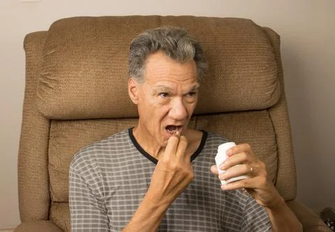 Man taking his medication Fotos Stock