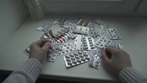 A man taking his temperature and choosing pills. Point of View Shot. POV video. Stock Footage 237941190