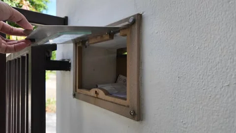 Man taking letter from the mailbox. Stockbeeldmateriaal 276692669