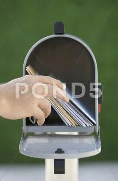 Man taking mail out of mailbox Stock Photos