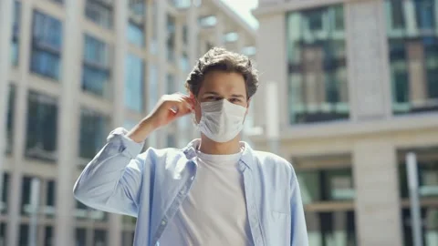 Man taking off mask and smiling at camera Stock Footage 134574129