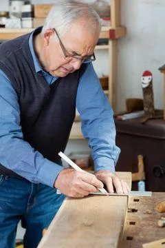 Man taking measurement using scale on wood Stock Photos