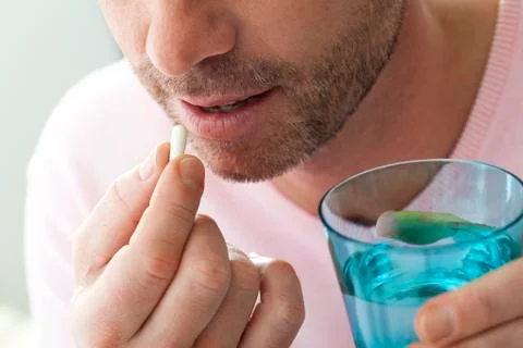 Man taking medication Stock Photos