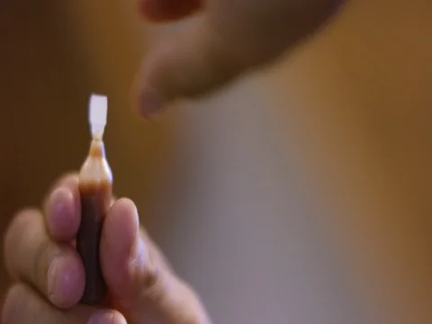 Man taking medicine liquid from small bottle Stock Footage 83303864