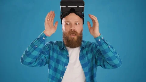 Man taking off modern 3D VR augmented reality glasses, shocked, interested Stock Footage 127626307