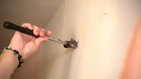 Man Taking Nails Out Of Wall Stock Footage 94609214
