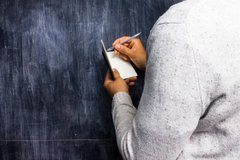 Man taking notes by blackboard Foto stock