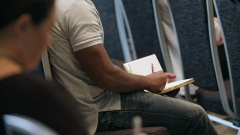Man taking notes in a book during a seminar Stock-Footage 92180038