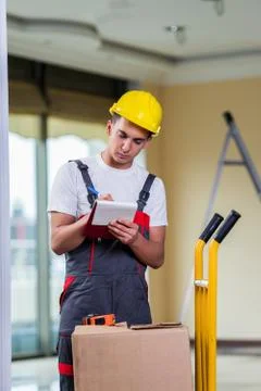 Man taking notes for delivery of boxes 写真素材