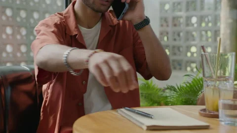 Man Taking Notes during Phone Conversation in Cafe Stock-Footage 235770478
