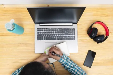 Man taking notes in front of the computer 스톡 사진