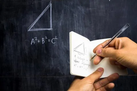 Man taking notes of math theorem on blackboard Stock-Fotos